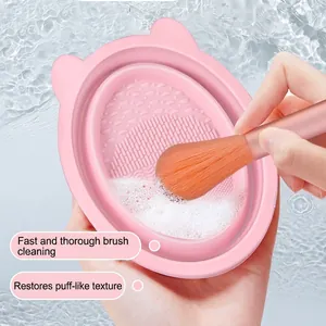 Pink silicone folding makeup brush cleaning bowl with textured base and cute cat ears design
