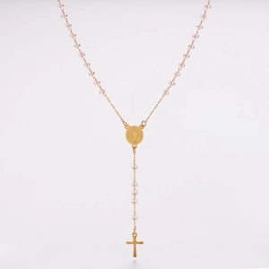 Close-up of pink crystal beads and golden Saint Benedict medal on a rosary necklace