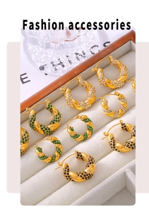 Detail of twisted gold U-shaped earrings inlaid with white, green, and black zircon