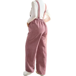 Detail of pink corduroy maternity overalls showing adjustable straps and high waist fabric
