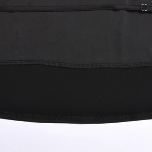Close-up of black fabric stitching and slit hem detail on sexy two-piece skirt set