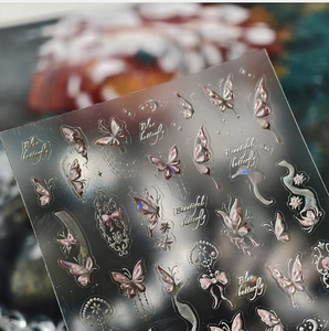 Macro detail of iridescent butterfly nail stickers with holographic purple gold foil accents