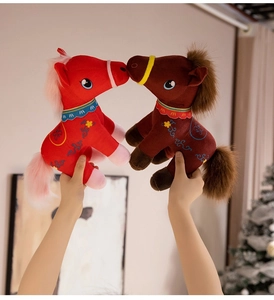 Detail of red and brown plush horse dolls with traditional Chinese embroidery patterns