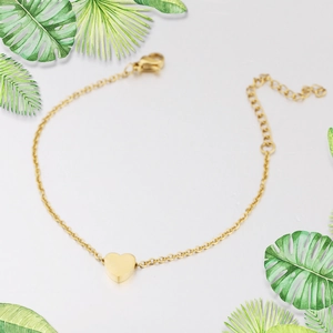 Detailed view of golden heart pendant chain with adjustable lobster clasp and green leaf decor