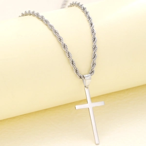 Detailed view of silver stainless steel cross pendant on a textured rope chain