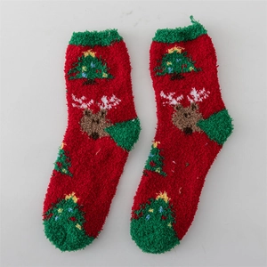 Red coral fleece Christmas socks featuring green heel and reindeer tree patterns