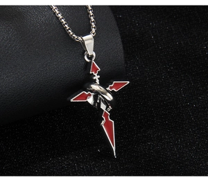 Detail shot of silver stainless steel cross pendant with red enamel on black leather