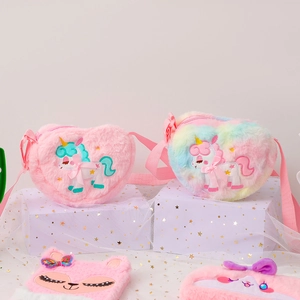 Close-up of heart-shaped plush unicorn bags with satin bows and soft rainbow fur detail