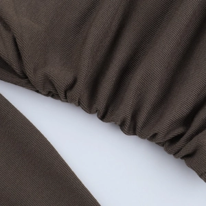 Detail of dark brown knit long sleeve top showing pleated seams and fine fabric texture
