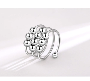 Macro shot of silver triple spiral stress relief ring with ten sliding metal beads