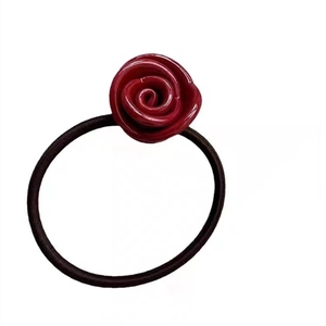 Elegant red rose hair tie with high-elasticity black band on a clean white background