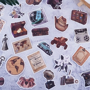 Flat lay of vintage aesthetic waterproof stickers featuring old maps and retro machines