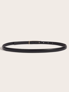 Detail of slim black leather belt featuring a golden pin buckle and adjustable holes