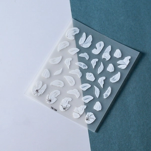 Detail of white 3D embossed petal nail stickers TS-134 on a dual-tone background