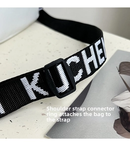 Close-up of nylon strap with white letters and plastic buckle on nylon crossbody bag