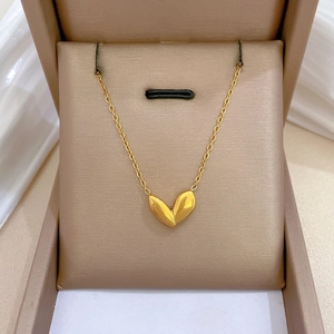Elegant gold titanium steel necklace with bud leaf pendant in a luxury jewelry box
