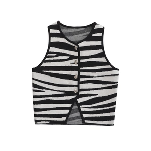 Detail of zebra pattern knitted vest showing the fabric texture and metallic buttons