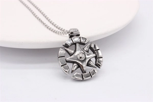 Détail macro du pendentif boussole rétro en acier avec finition argent vieilli sur chaîne
