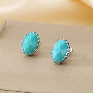 Detailed side view of oval turquoise glass stud earrings with silver hollow edge