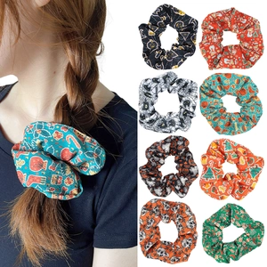Holiday themed hair scrunchies set for Halloween and Christmas with festive patterns