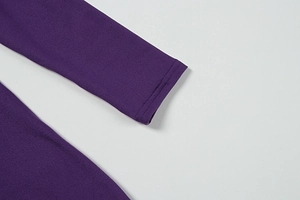 Close-up of double-needle stitching on purple long-sleeved dress cuff texture