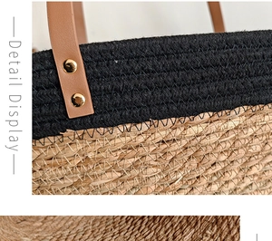 Detail view of woven straw tote featuring brown leather handles and gold rivet accents
