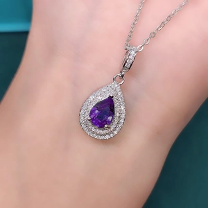 Exquisite teardrop necklace featuring a pear-cut purple gemstone with diamond pavé border