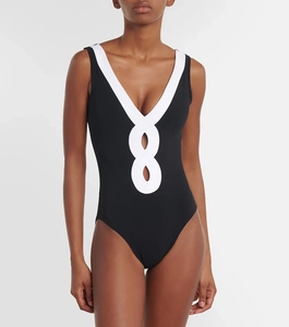 Detail of deep V-neckline with black and white contrast cutout on monokini swimsuit