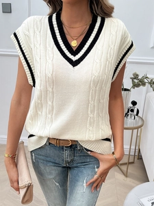 Close-up of the V-neck detail with black stripes and cable knit texture on the white vest