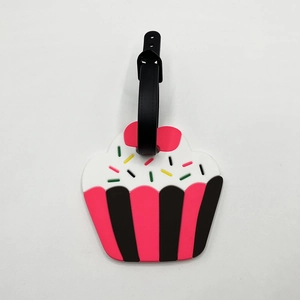 Close-up of a pink cupcake silicone luggage tag with colorful sprinkles and black strap