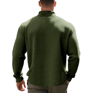 Macro shot of dark army green waffle knit texture on a men's stand collar sweatshirt