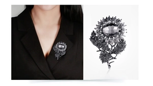 Detailed view of sunflower brooch with dark grey crystals and charcoal metallic finish
