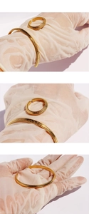 Close-up of gold plated snake bone textured open ring and bracelet jewelry set