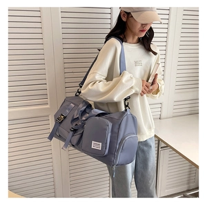 Close-up of fog blue travel bag with adjustable strap and independent shoe compartment