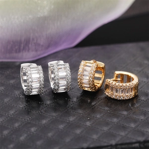 Luxurious gold and silver hoop earrings featuring full baguette and round pavé zircon stones