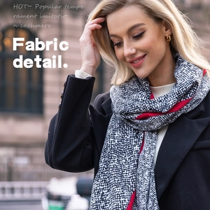 Elegant snake print cashmere feel scarf with red borders on a fashion model