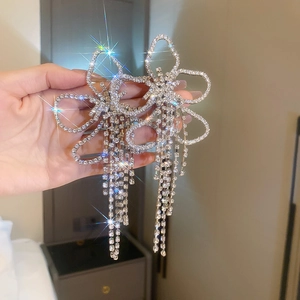 Detail shot of oversized floral tassel earrings with high-shine crystal rhinestones