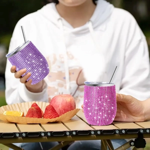Detailed view of rhinestone studded purple and pink insulated tumblers for outdoor picnic