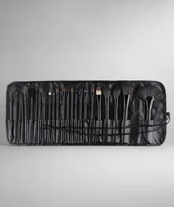 Detail of 24-piece professional makeup brush set arranged in a black leather roll-up bag