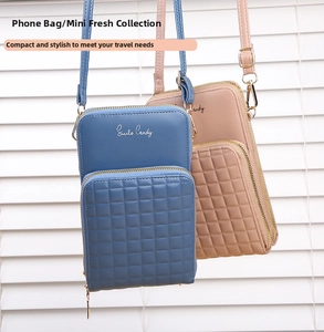 Detail view of mini crossbody phone bags in dark blue and nude pink with gold hardware