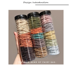 Detailed view of high-elasticity braided hair ties in three assorted color storage jars