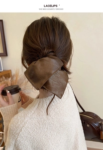 Brown leather textured bow hair tie on hair, retro pleated design accessory for women