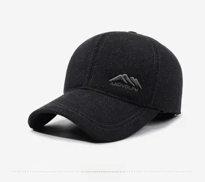 Detailed close-up of dark grey wool blend baseball cap with mountain logo embroidery