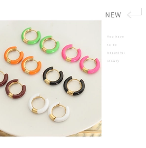 Close-up of colorful enamel and gold plated hoop earrings in six vibrant shades