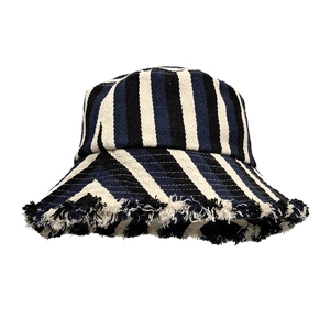 Detail of striped cotton bucket hat featuring frayed edges and textured knit fabric