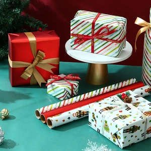Christmas gift wrapping paper with nutcracker prints and festive red ribbons on gold stand
