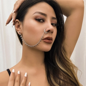 Detail showing silver nose-to-ear chain with ethnic crescent moon tassel charms
