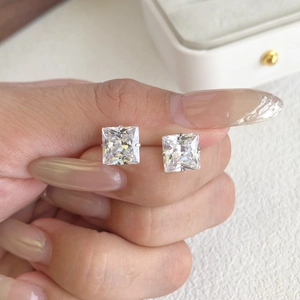 Close-up of S925 sterling silver square zircon stud earrings worn on the ear for size