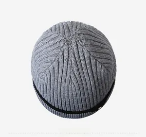 Top-down view of grey knit beanie featuring vertical stripe texture and black trim edge