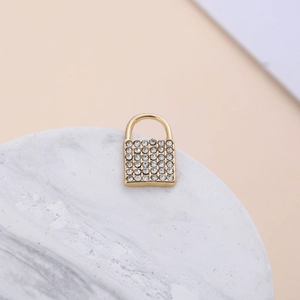 Close-up of gold-plated alloy padlock pendant with micro-pave clear crystals for jewelry